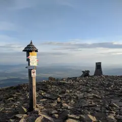 Szczyt Babiej Góry z drogowskazami. Warto wiedzieć, ile się wchodzi na Babią Górę, by docenić widoki!